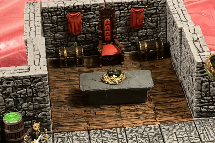 A boy playing Dungeons & Dragons raises his arms in victory.